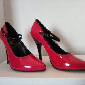 Size 7 unworn shiny red pumps. Black straps. Unworn.Original box.